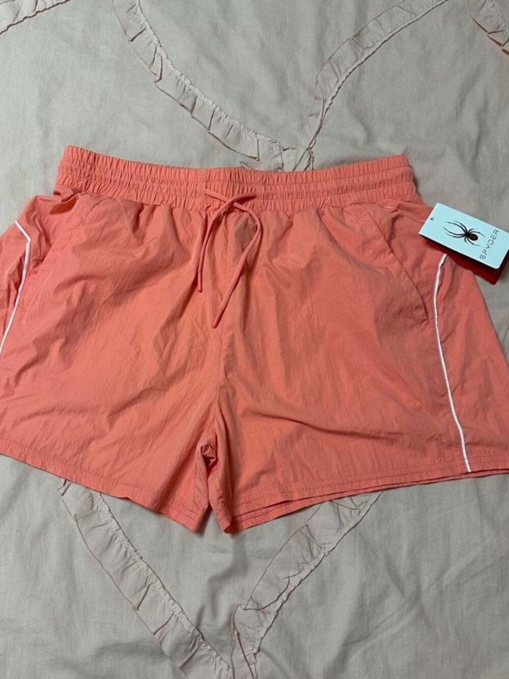 NWT Spyder peach/coral athletic running shorts with slash pockets.